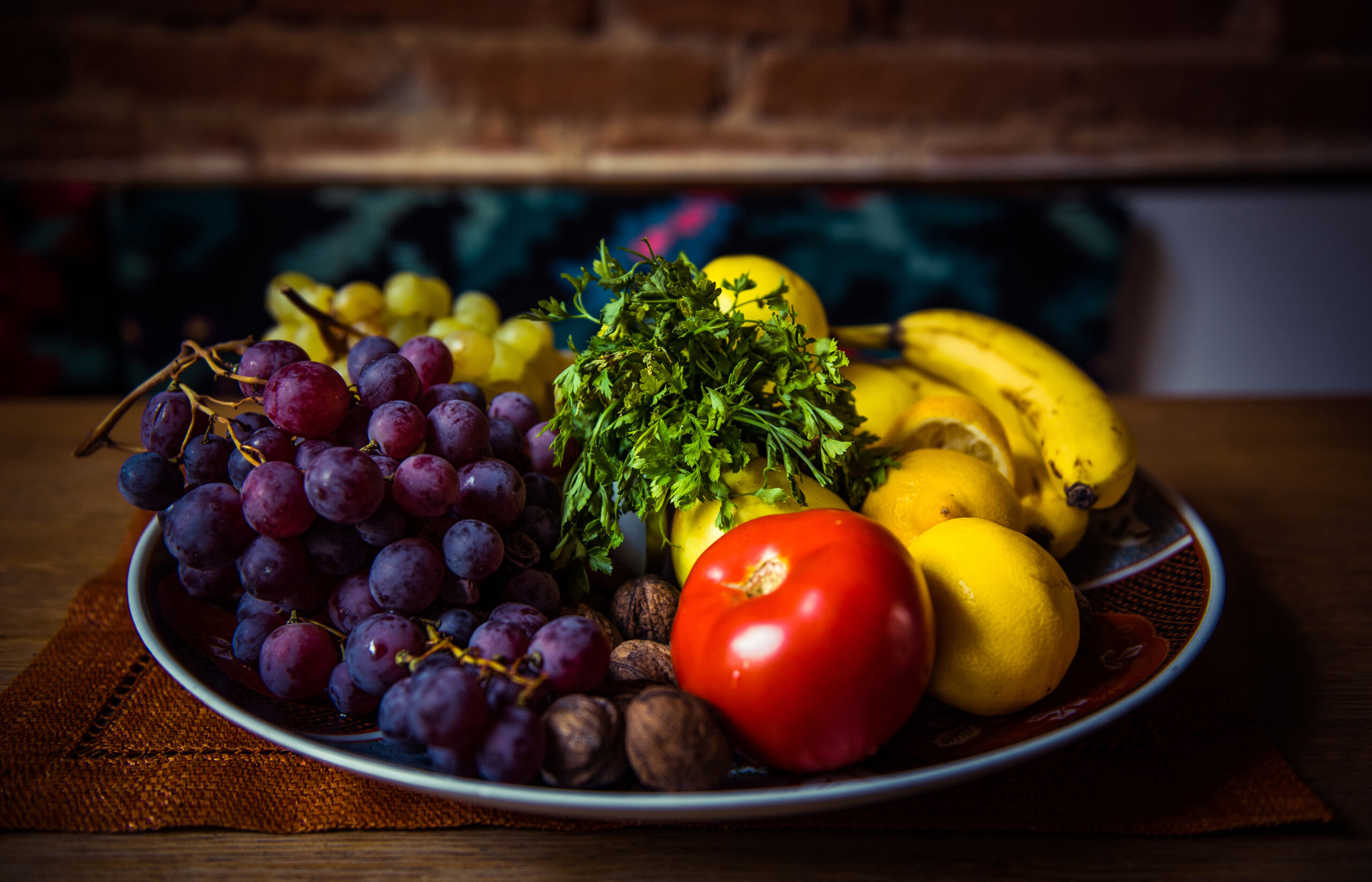 Assortment of juicy fruits in a bowl on wooden table